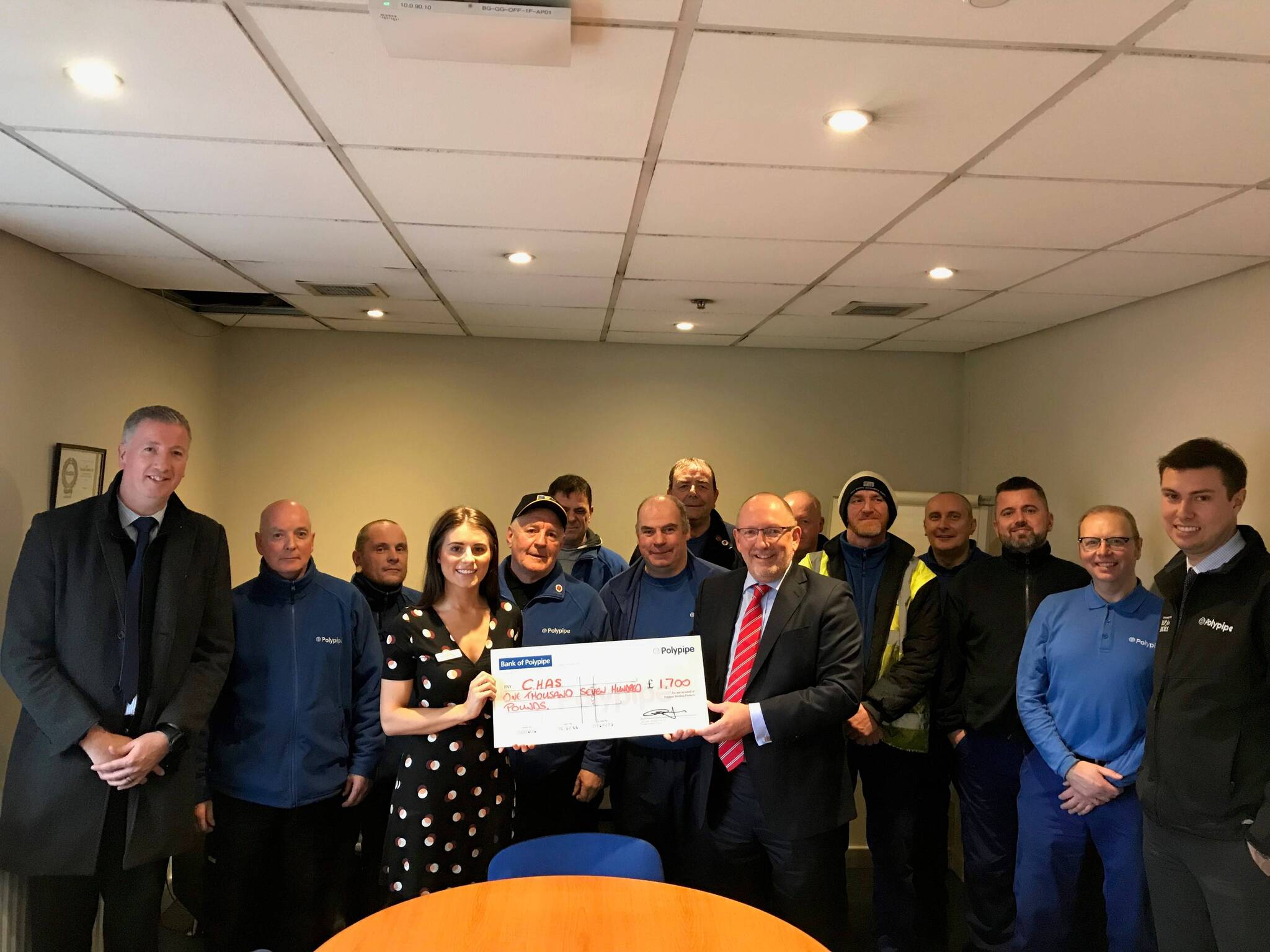 Polypipe Glasgow site celebrates 2000 days accident free The Polypipe Team presenting their cheque to Megan from CHAS